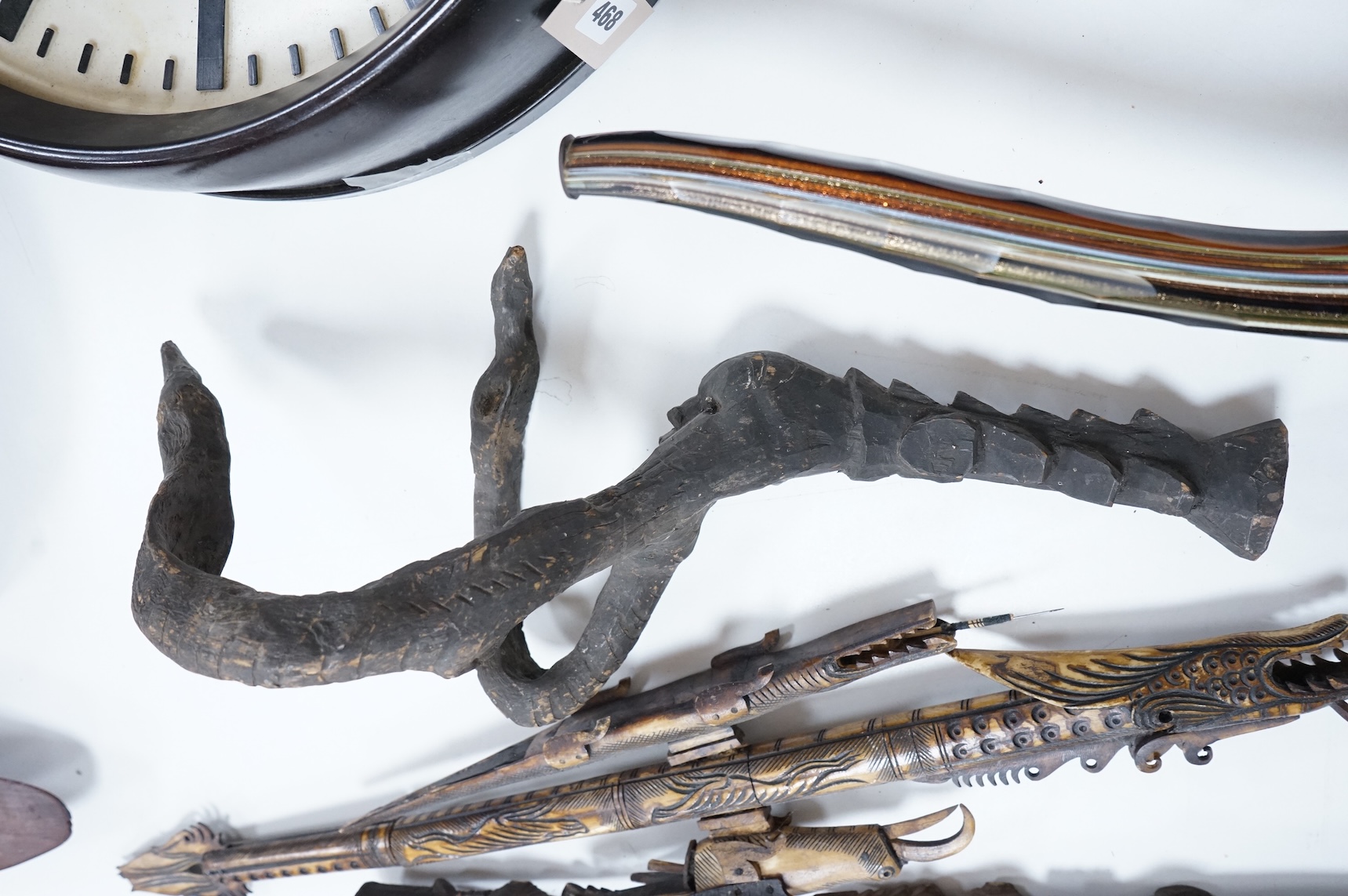 Two Papua New Guinea Sepik River carvings and a carved bone artefact, largest 92cm in length